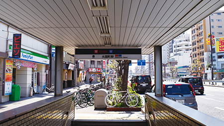 ① 大阪メトロ御堂筋線・四つ橋線「大国町駅」1番出口より地上へ上がると、右手に国道25号線、左手にファミリーマートがあります。